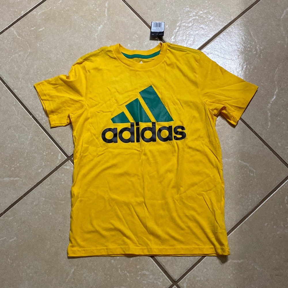 Adidas shirt boys colors are yellow/green/black letters. New with tags 🎾🏸🏇🏻